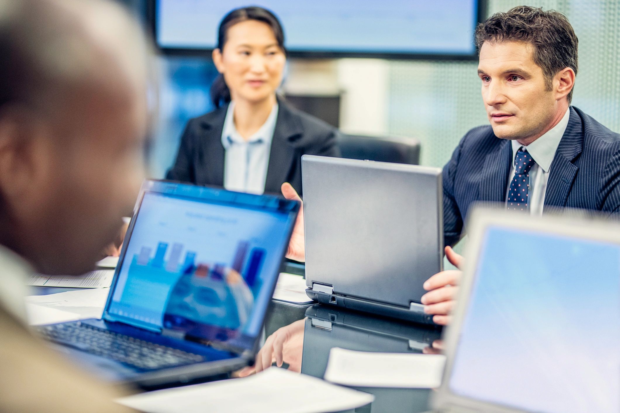 Business advisory meeting with laptops